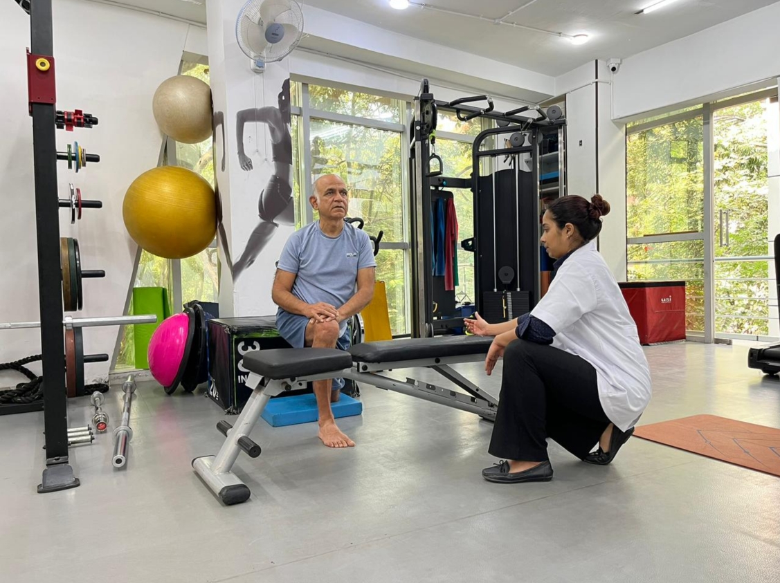 Physiotherapist helping patient walk after surgery